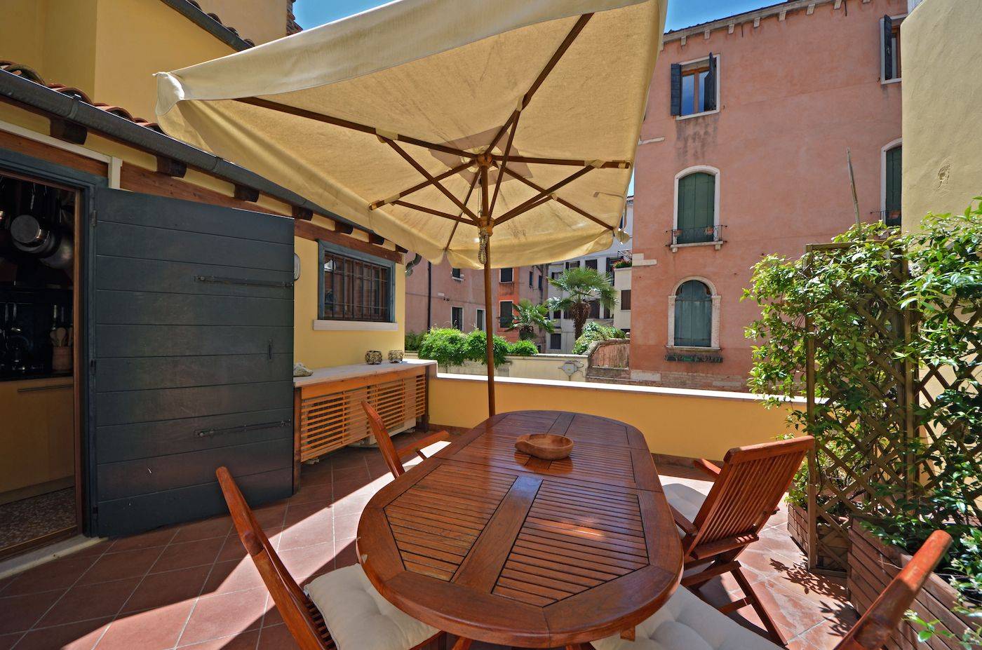 there is a table for up to 6 people and a large sun umbrella there is a table for up to 6 people and a large sun umbrella