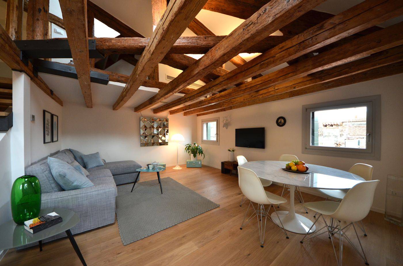 natural parquet flooring and antique wooden beamed ceiling confer warmth to the ambience