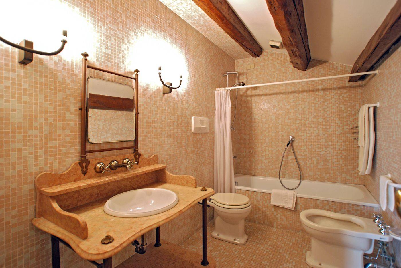 the elegant bathroom of the attic with bathtub and mosaic tiles