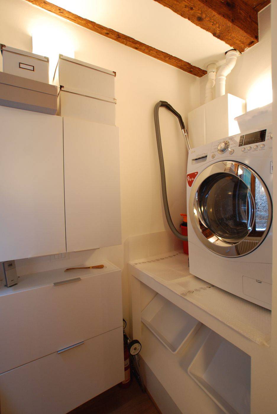 there is also a small laundry with all-in-one washer and dryer
