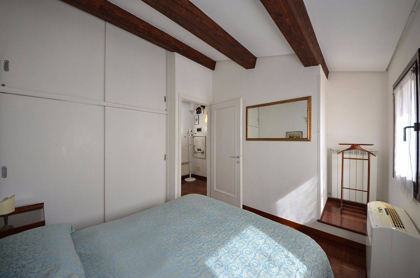 comfortable master bedroom with large wardrobe