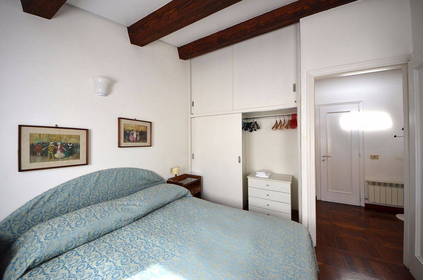 comfortable master bedroom with large wardrobe