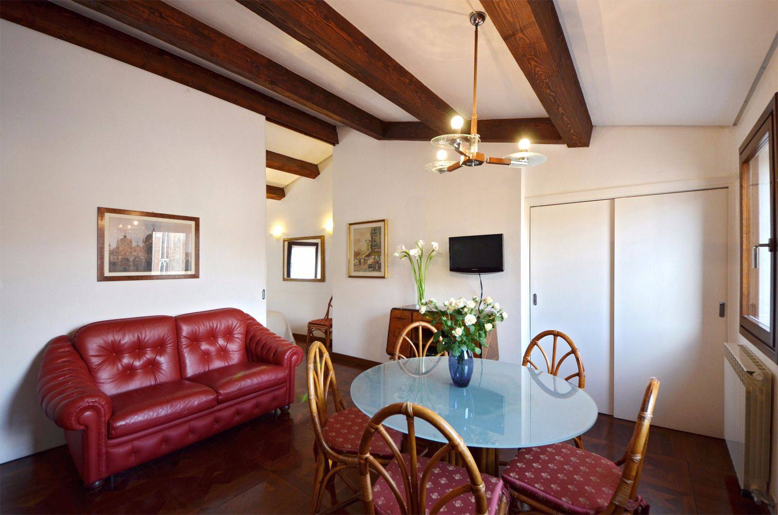 the sliding wall behind the sofa-bed in the living room hides the second bedroom