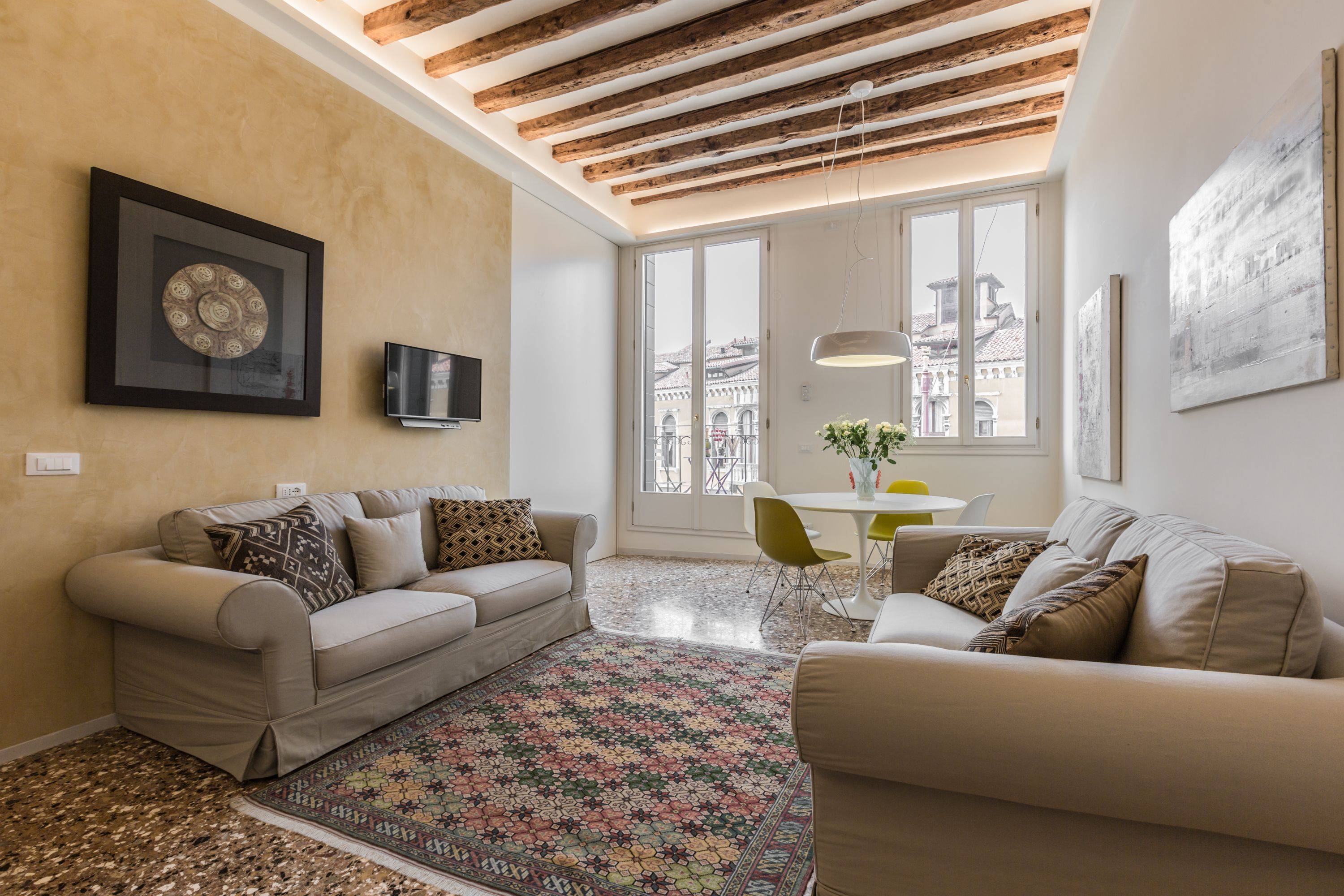 comfortable sofas, terrazzo Veneziano flooring, antique wooden beamed ceiling, plenty of natural light