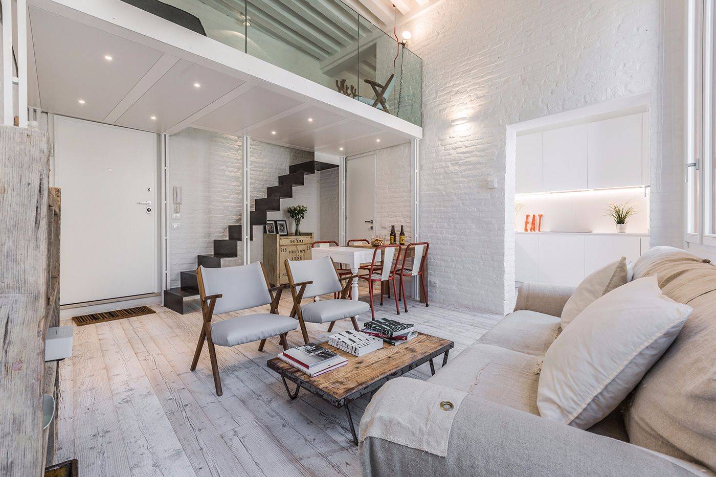 in the living room there is a mezzanine accessible through a nice metal stairway