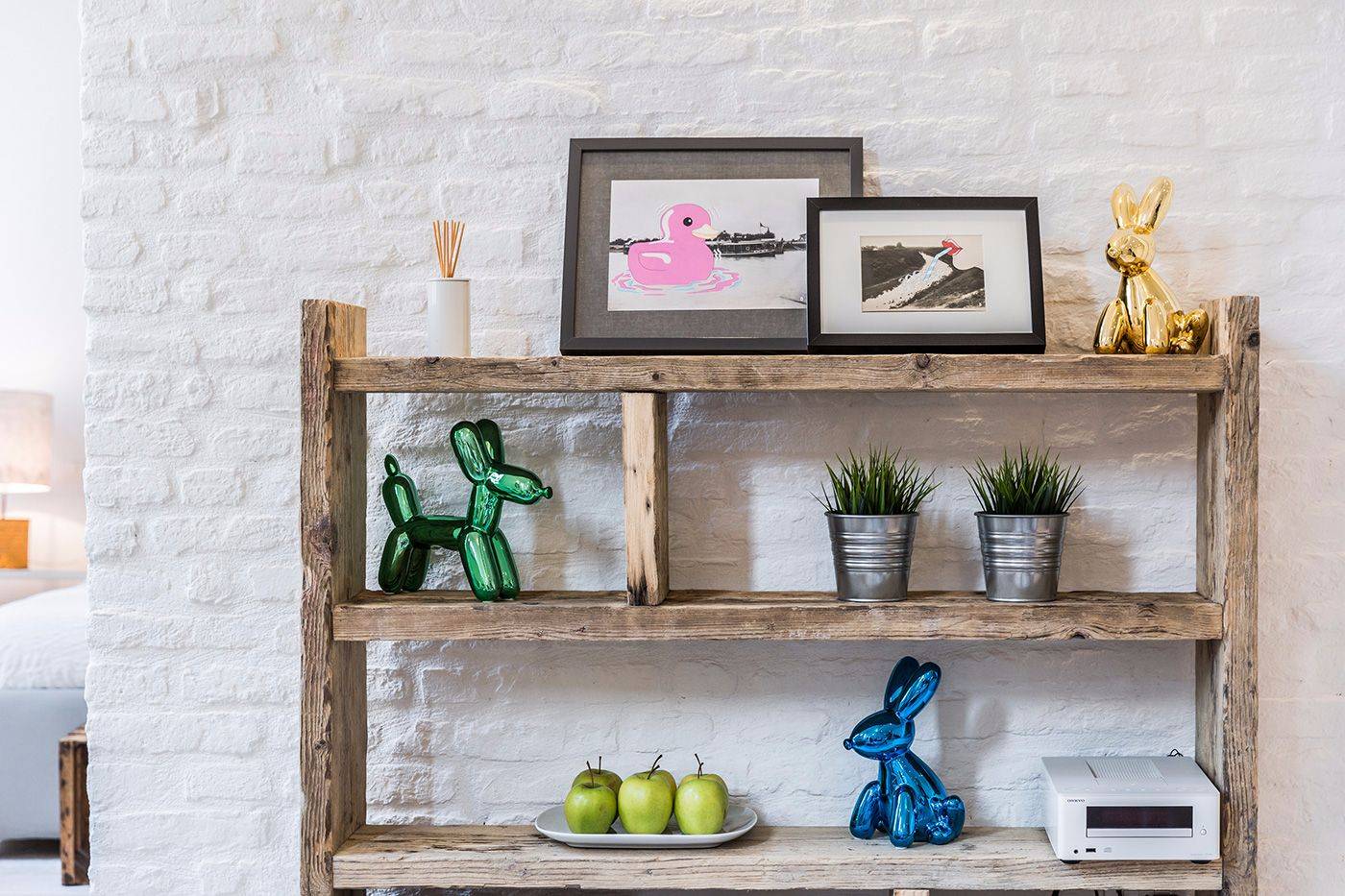 painted white brick walls enhance the colorful objects