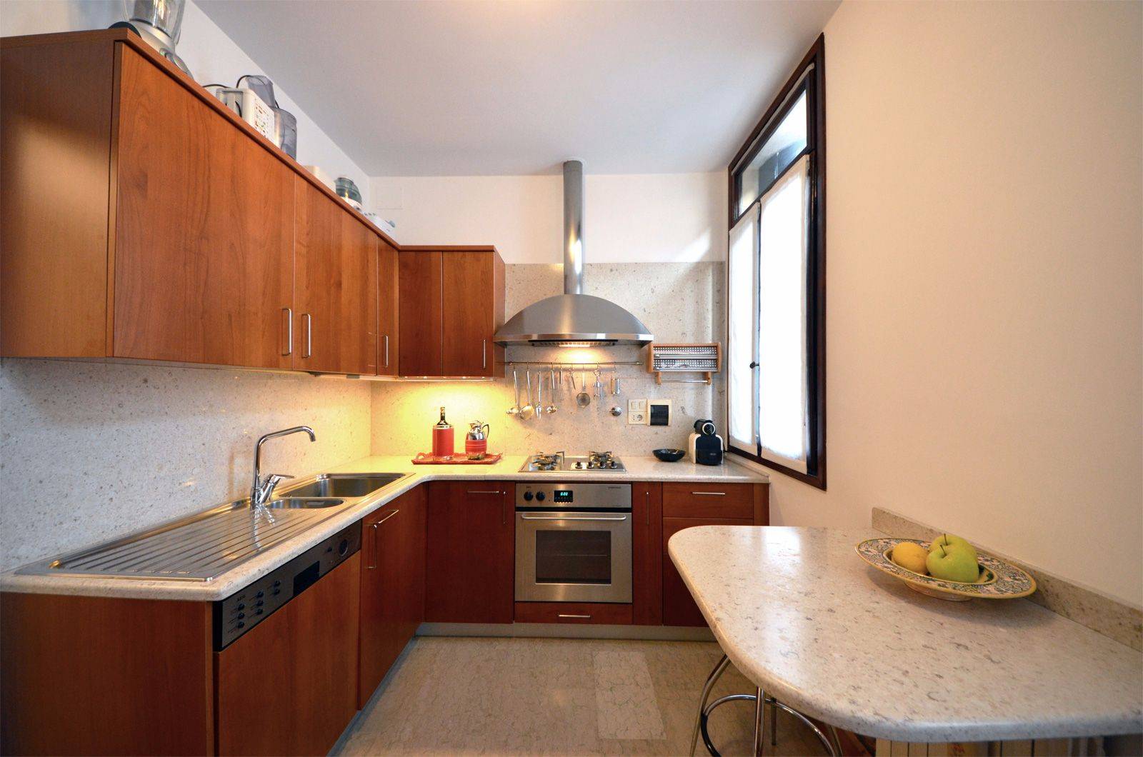 fully equipped kitchen with small breakfast table 