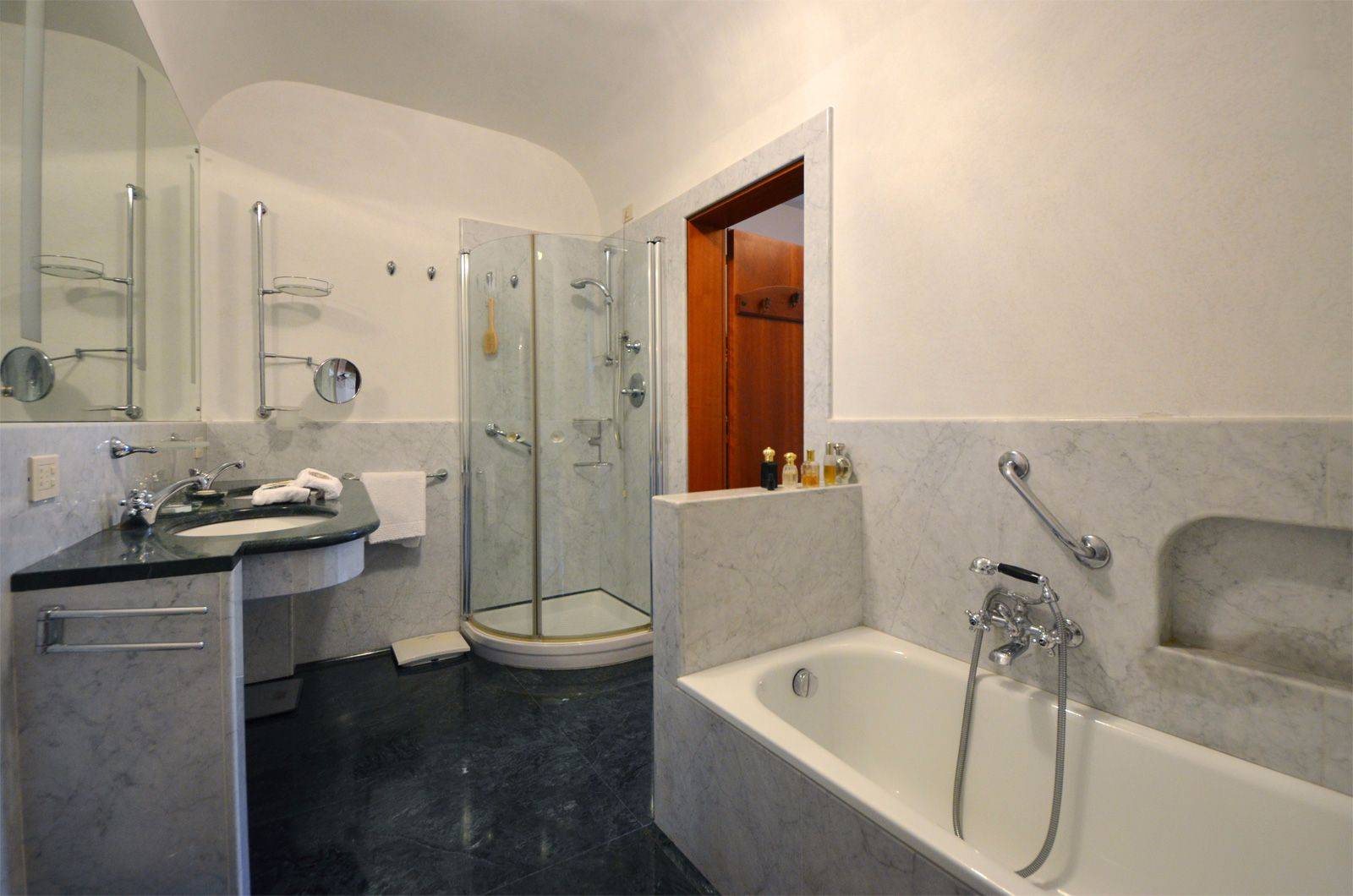 en-suite bathroom with bathtub and large shower cabin