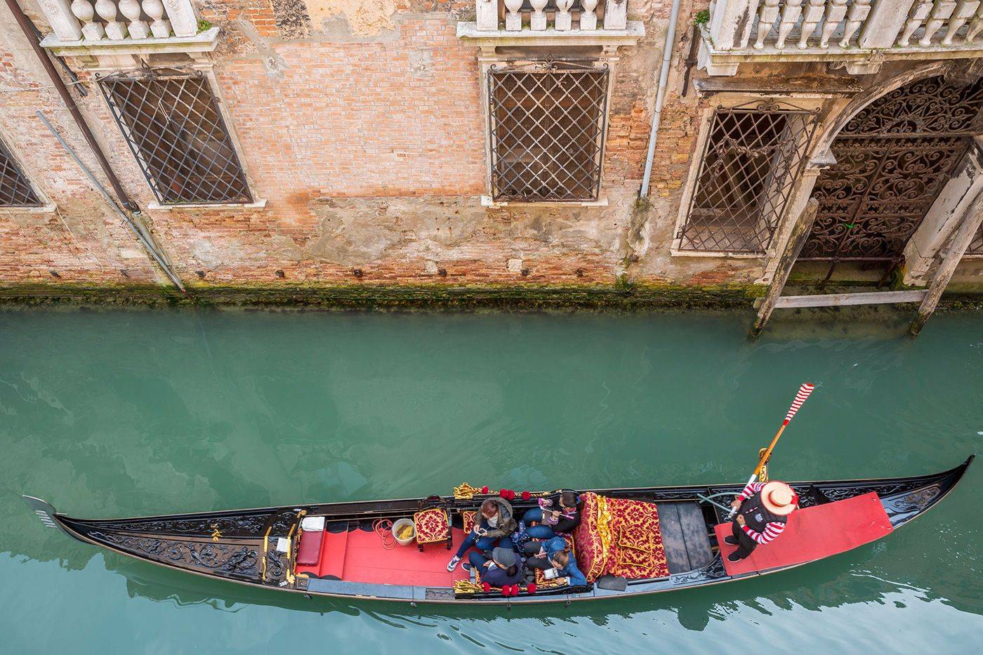 enjoy the serenades of the gondoliers rowing along the canal