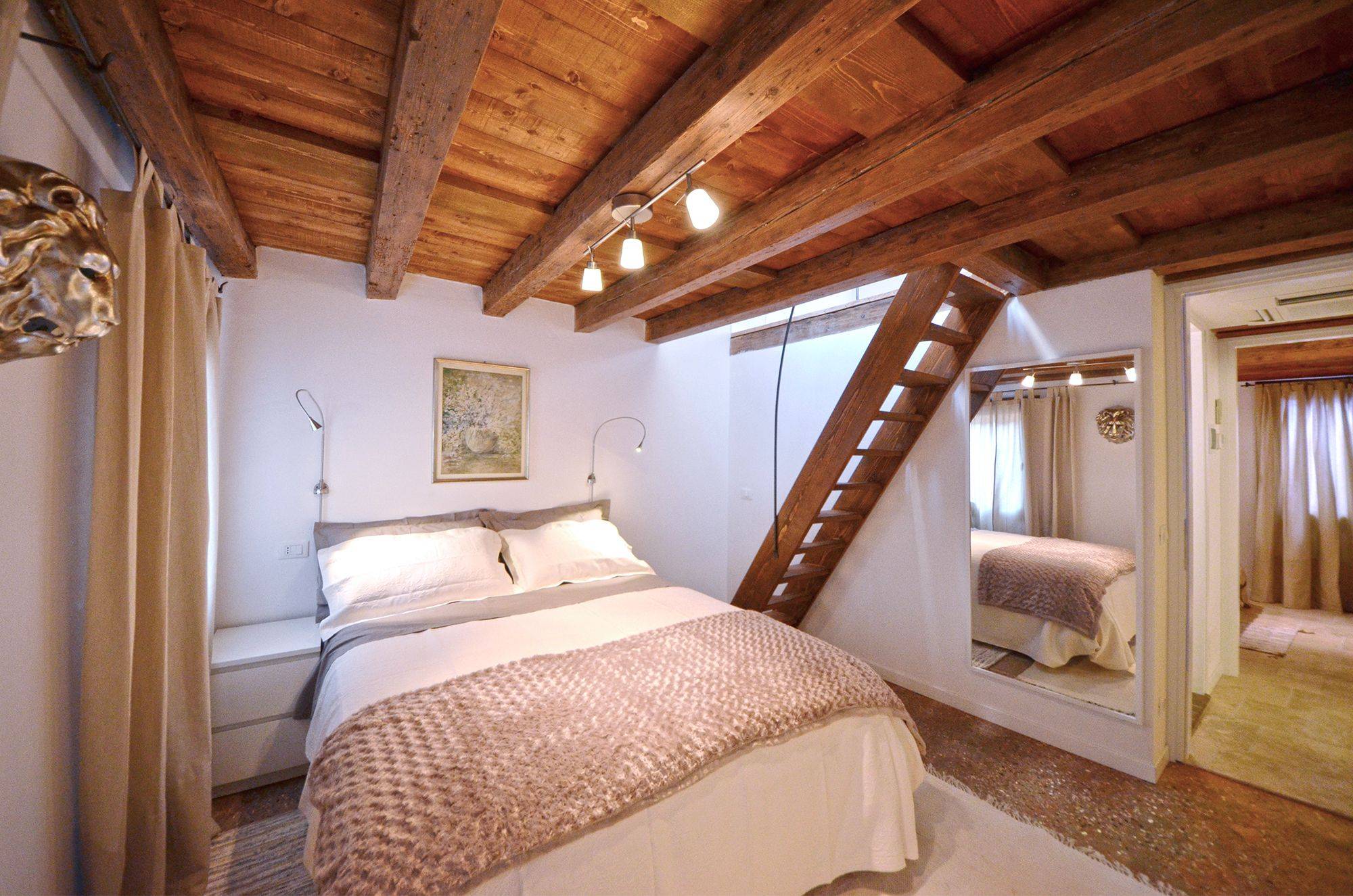 the double bedroom has plenty of wardrobe space and a staircase to the attic
