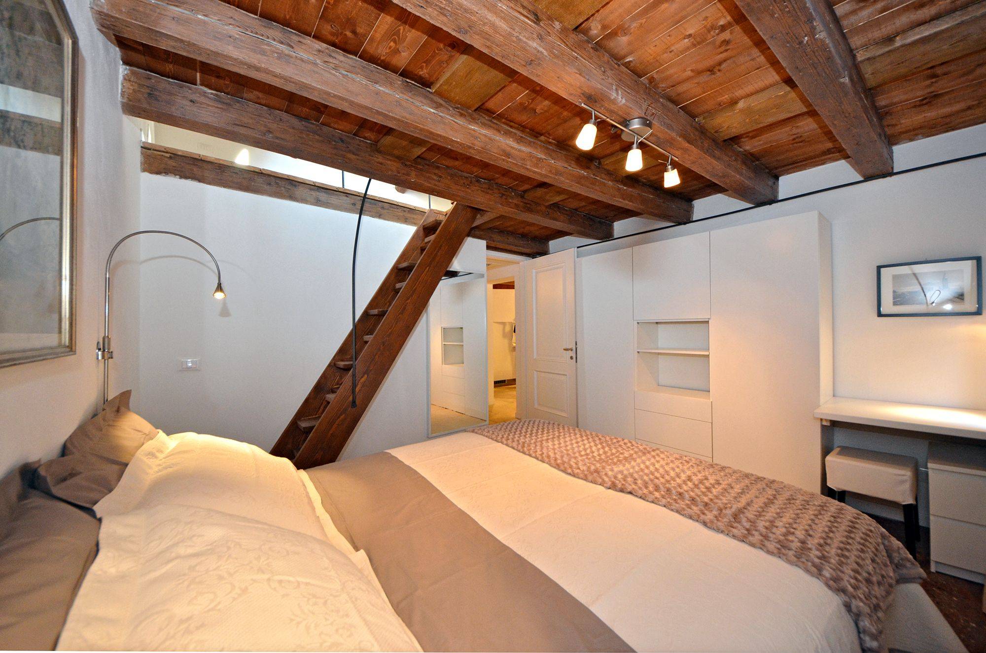 the double bedroom has plenty of wardrobe space and a staircase to the attic