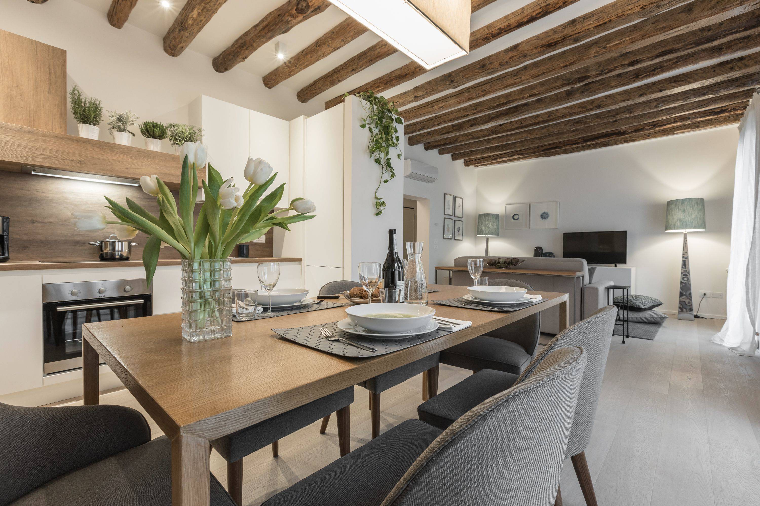 nice parquet flooring and antique wooden beamed ceiling confer warmth to the ambience