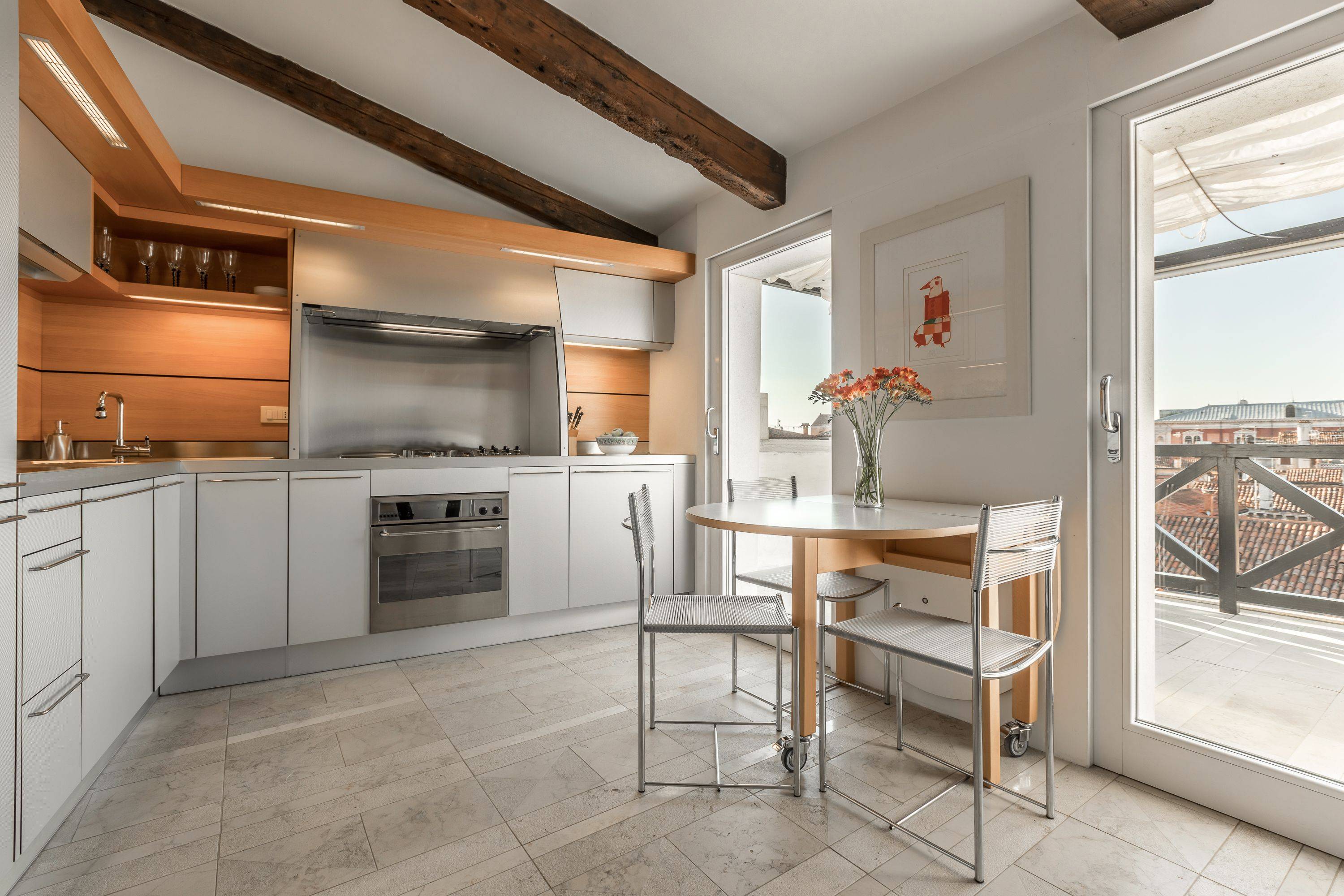 the spacious kitchen is found between the living room and the terrace
