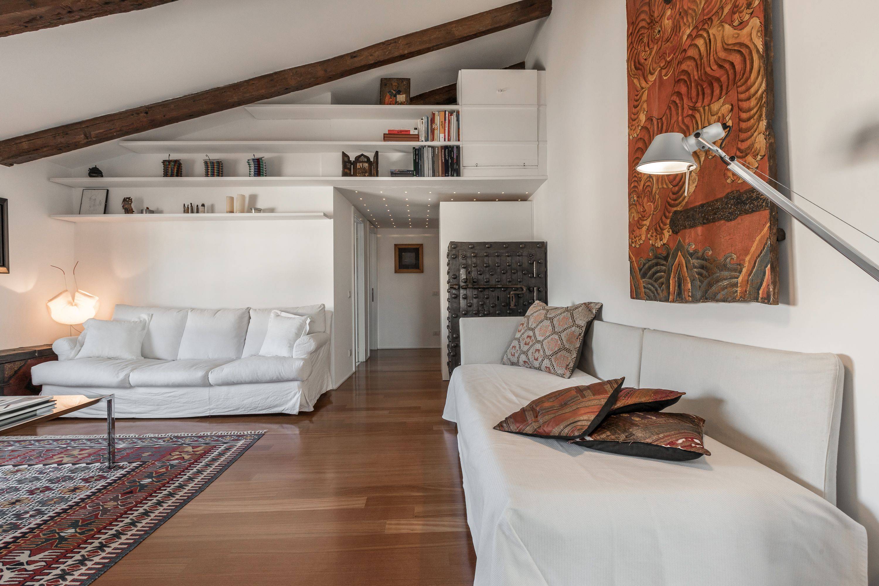in the living room there is a single comfortable sofa-bed