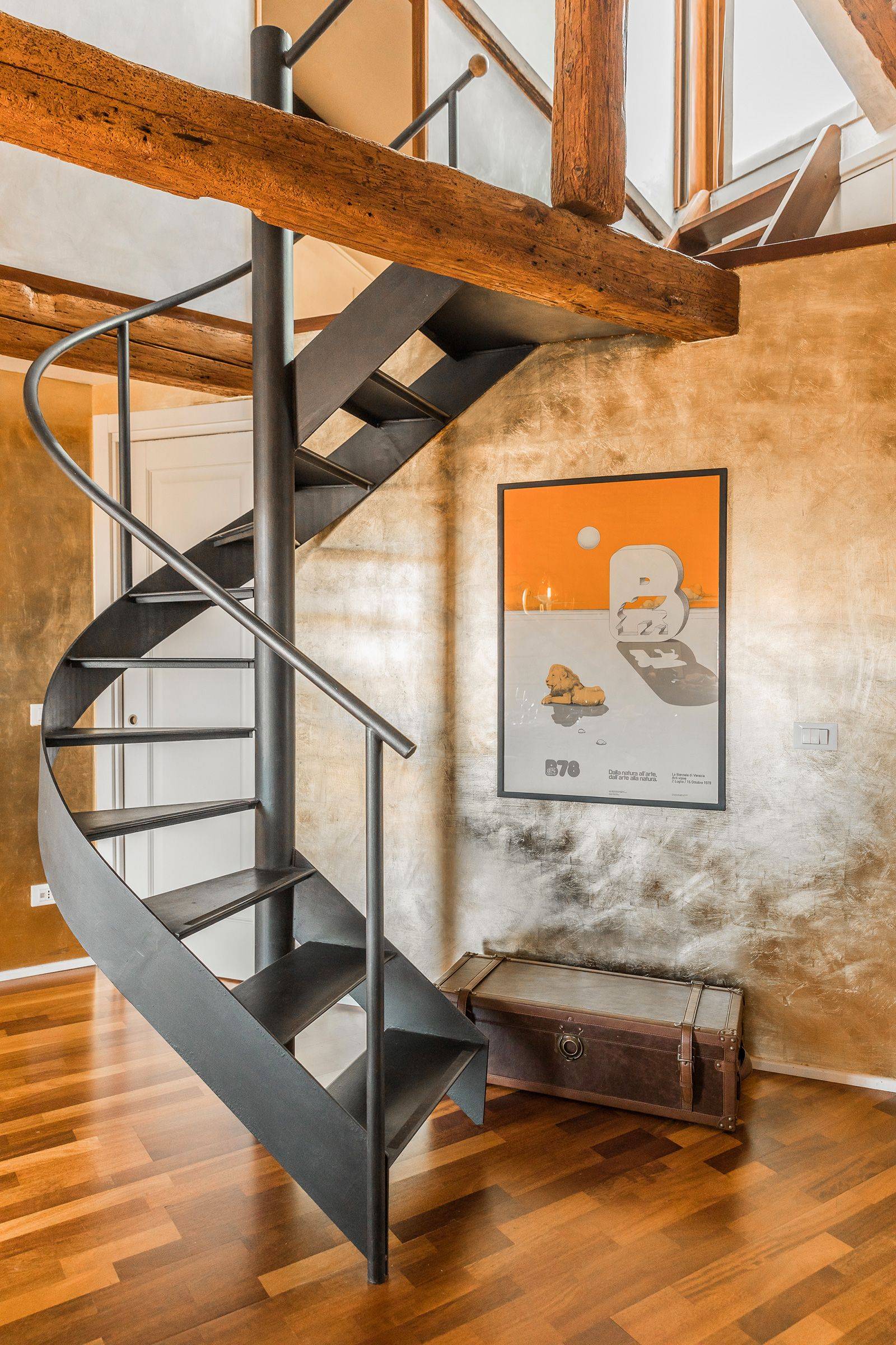 there is an easy to climb spiral staircase leading to a small gallery and the terrace