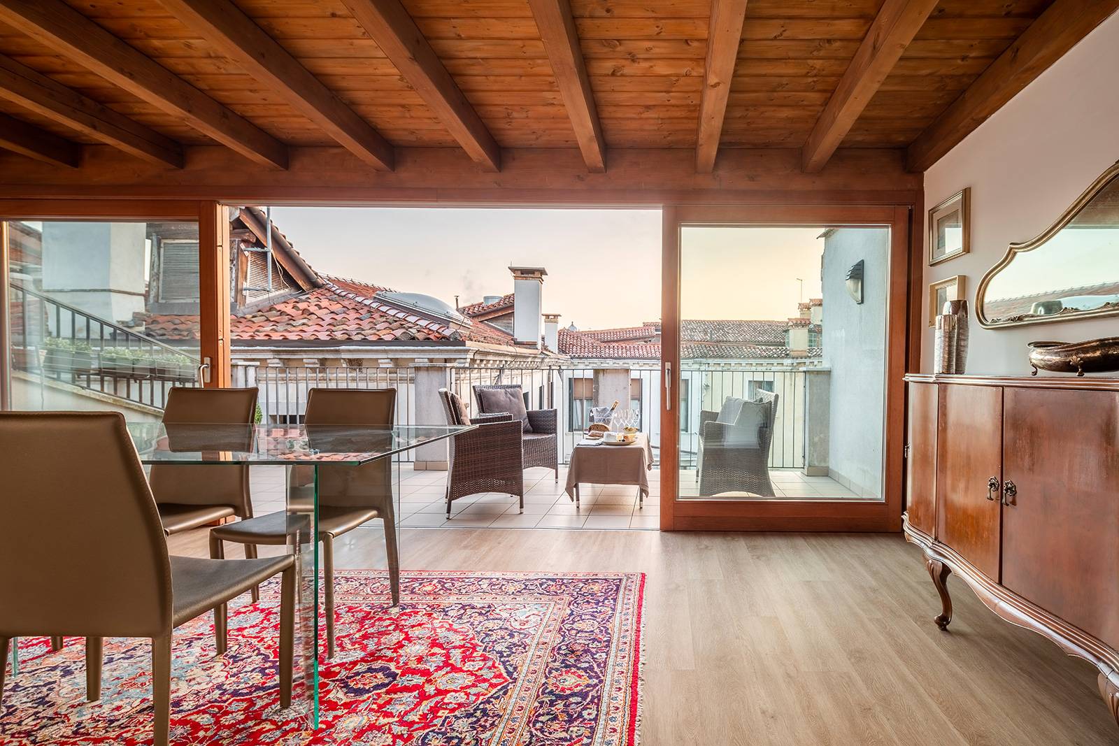 this room is flooded with natural light and offers picturesque views over the roof tops of Venice