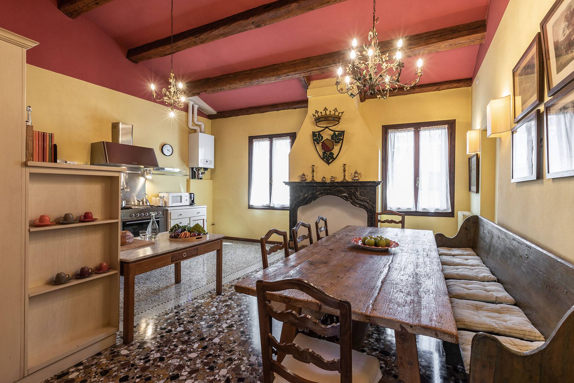 the huge kitchen is also equipped with a large antique wooden dining table the huge kitchen is also equipped with a large antique wooden dining table