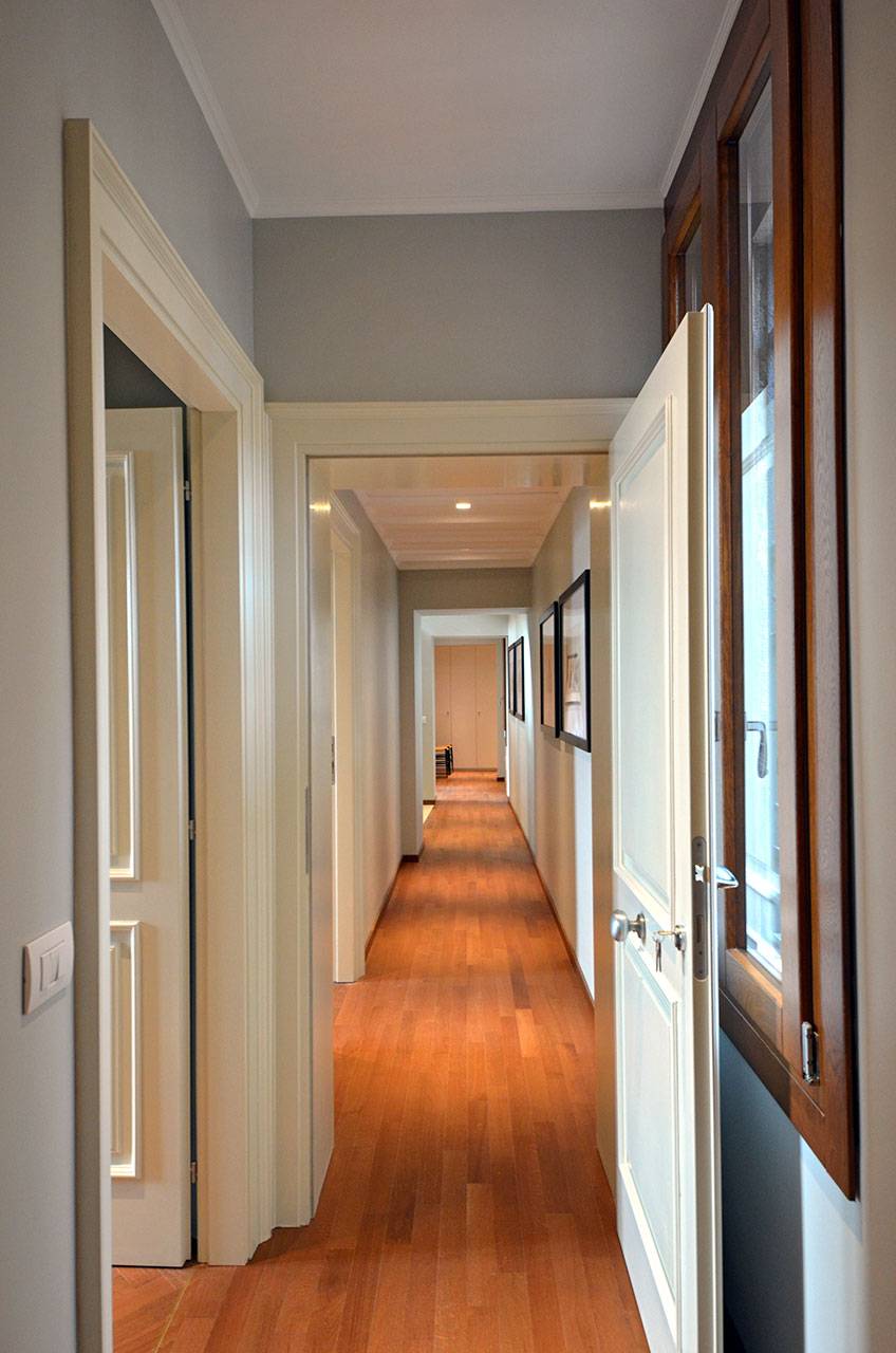 corridor connecting the 3 bedrooms on the front to the dining room and bedroom on the back