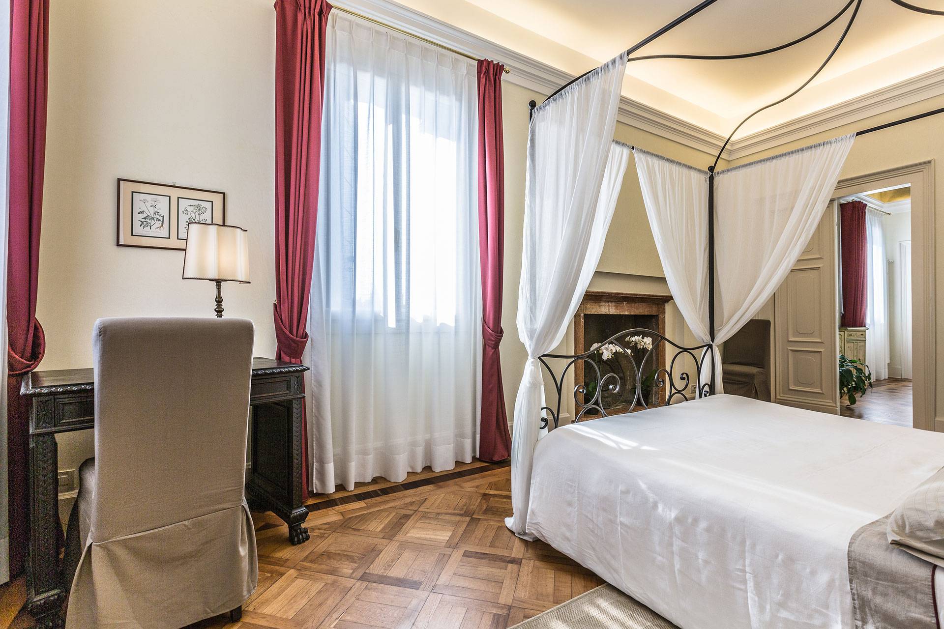 the master bedroom boasts a canopied bed dressed with nice linen