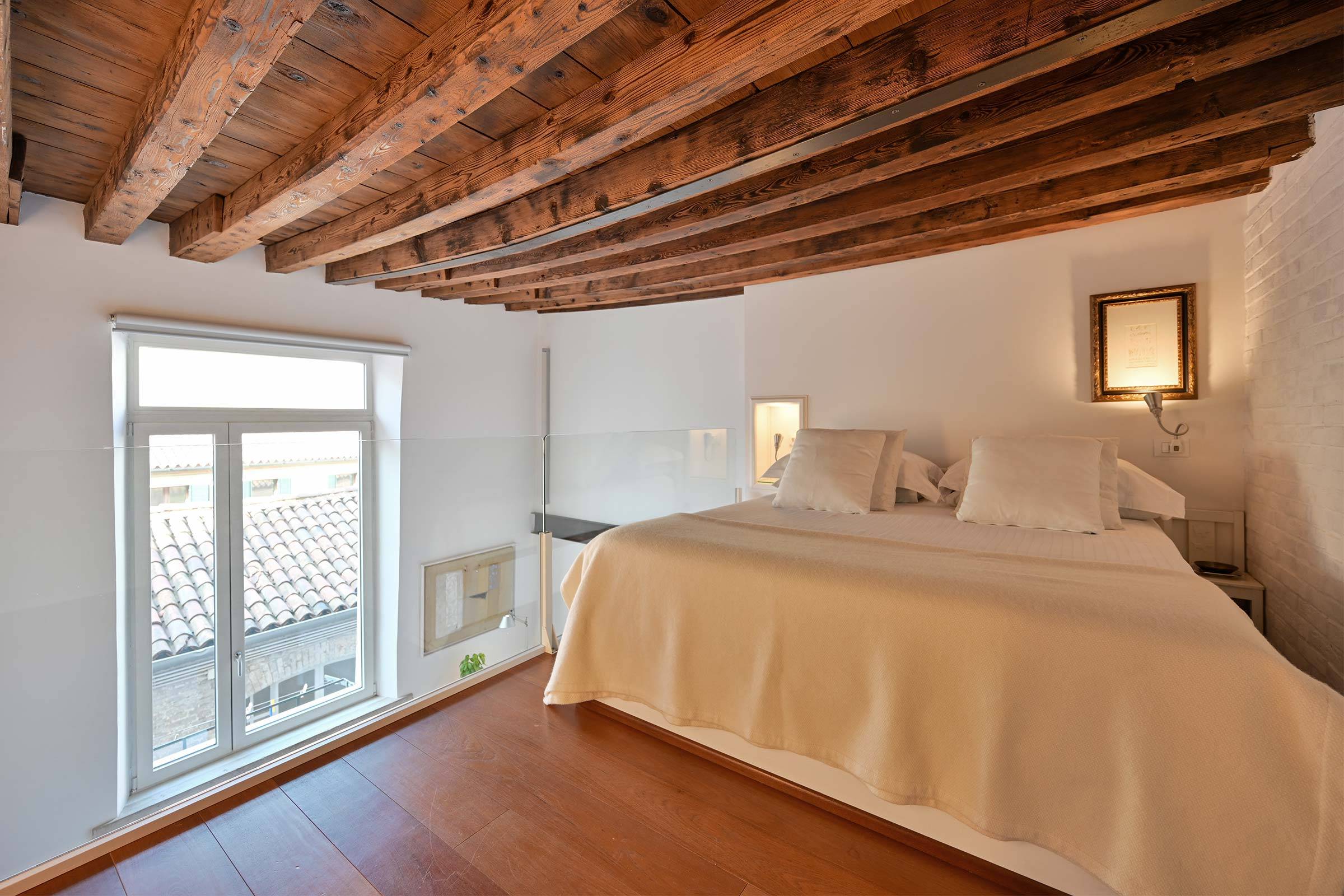 spacious bedroom in the gallery, the height of the wooden beams is about 180 cm