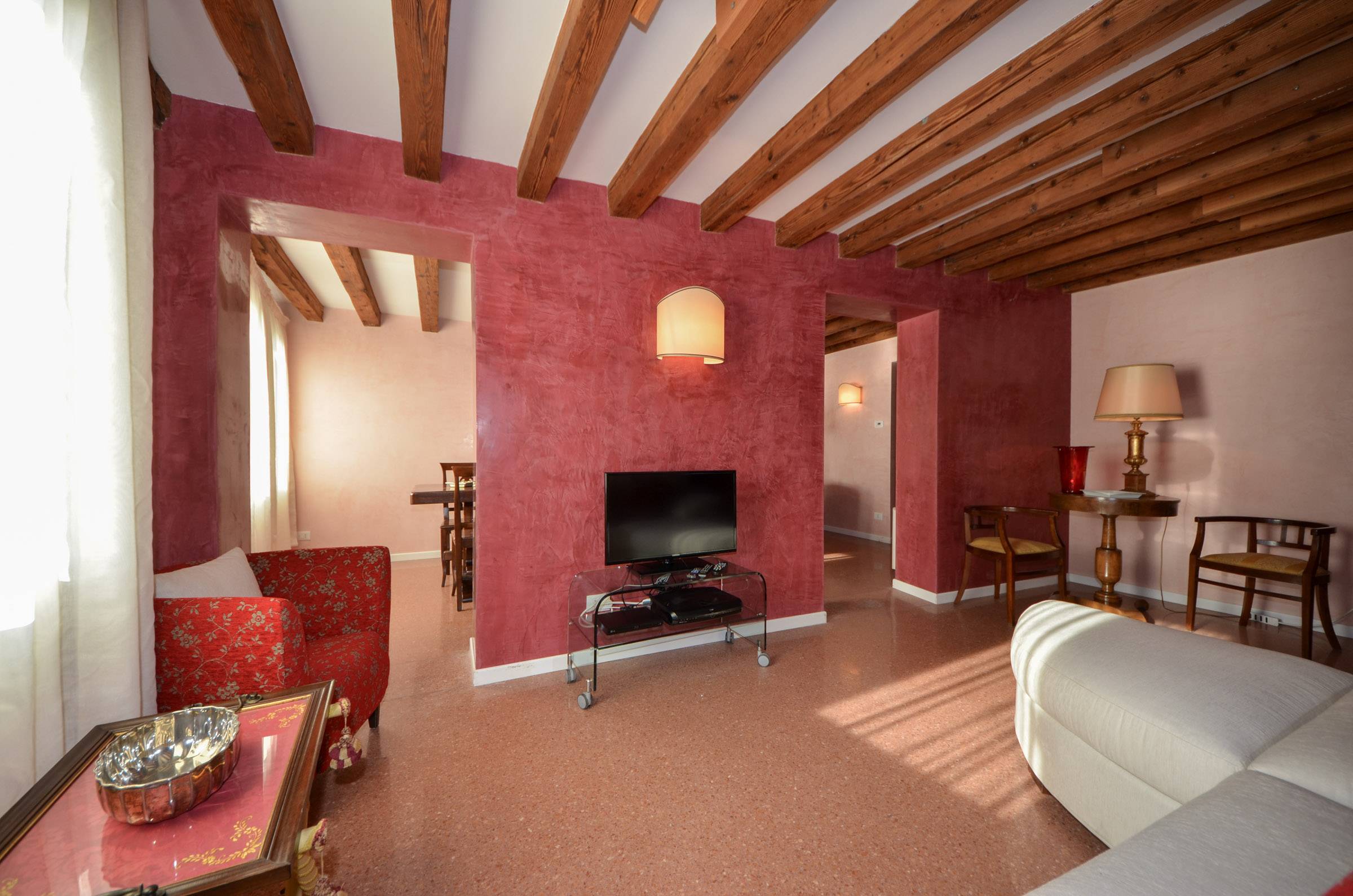 terrazzo veneziano flooring, stucco veneziano paint and wood-beamed ceilings