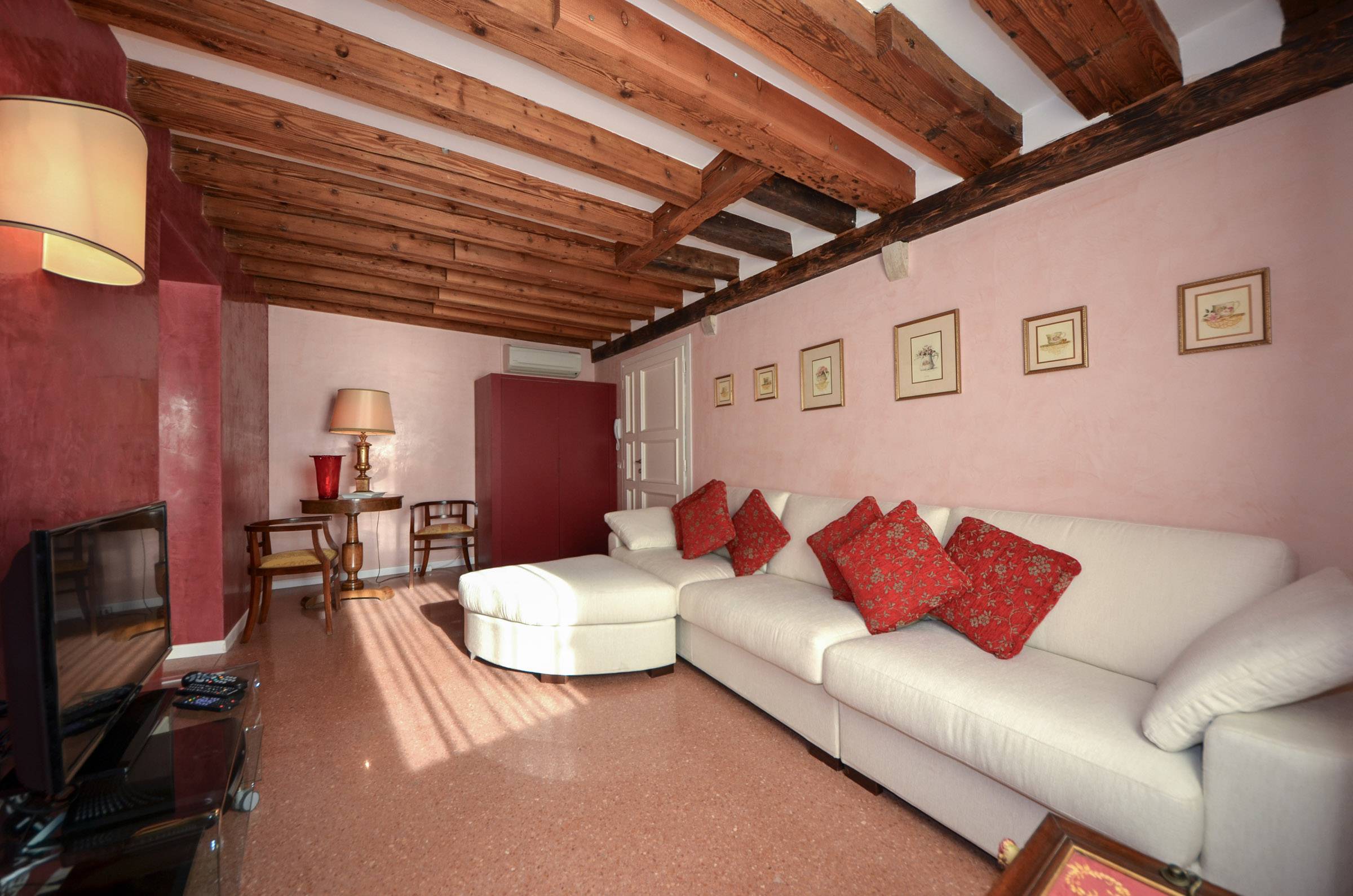 terrazzo veneziano flooring, stucco veneziano paint and wood-beamed ceilings