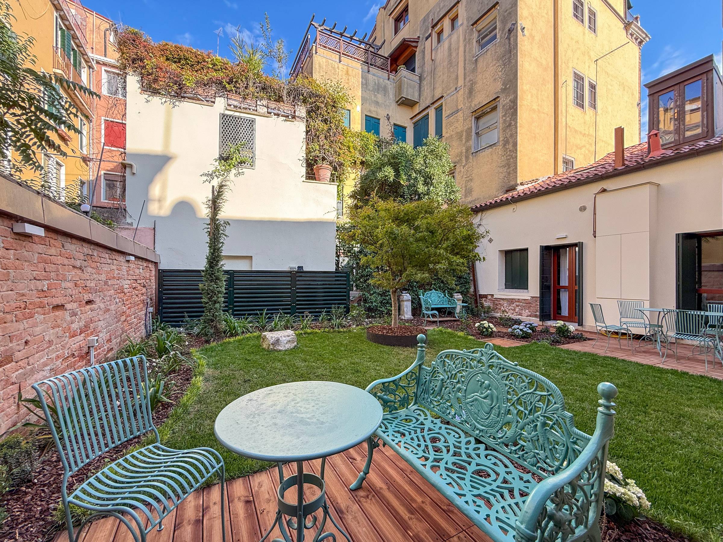 with beautiful wrought iron table and 4 seats with beautiful wrought iron table and 4 seats