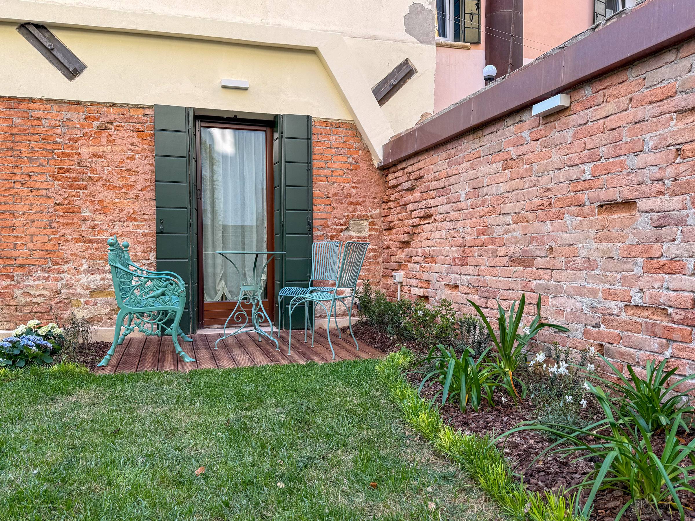 with beautiful wrought iron table and 4 seats with beautiful wrought iron table and 4 seats